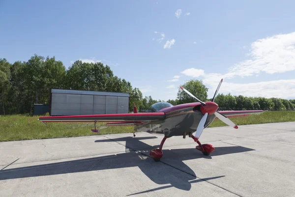 Small sport airplane in a big lot — Stock Photo, Image