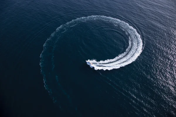 Motor boat making a turn in form of a swirl — Stock Photo, Image