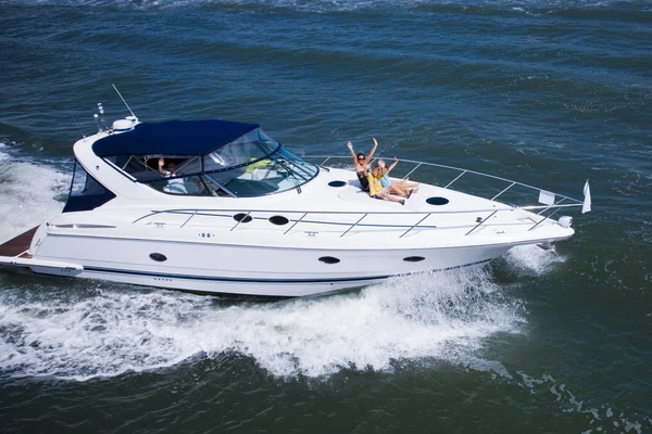 Mother with two kids sitting in a yacht — Stock Photo, Image