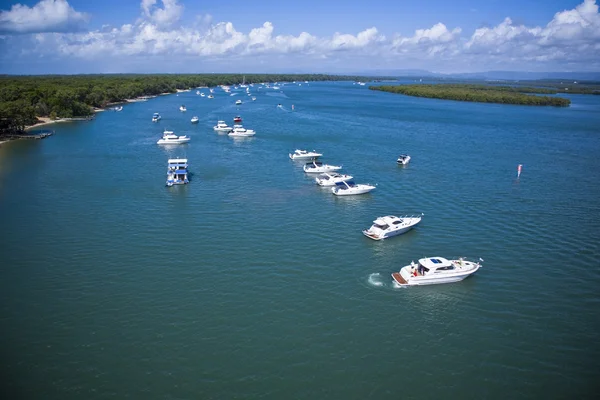 A group of yachts lined up in the sea Stock Picture