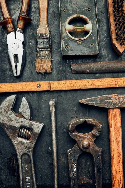 Old hardware tools. Wrench, screwdriver, measure, hammer, pliers on steel surface. Mechanic tools for maintenance. Hardware tools to fix. Technical background with copy space