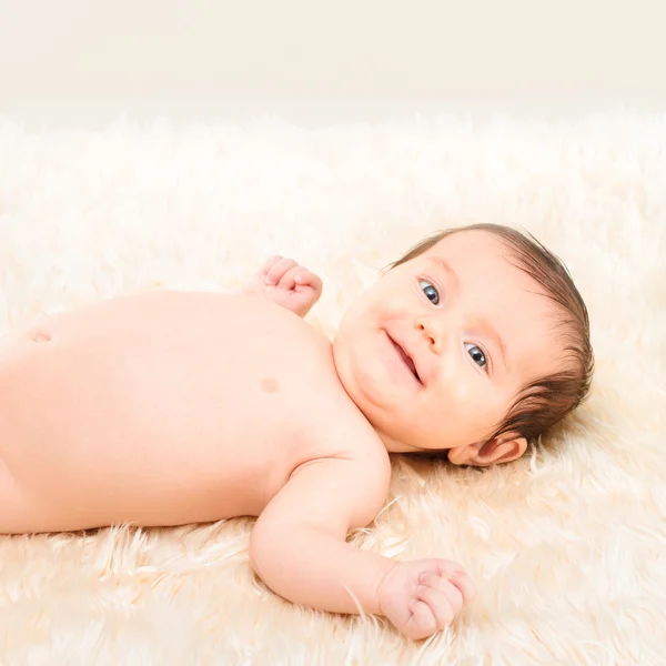 Baby girl lying on furry blanket — Stock Photo, Image