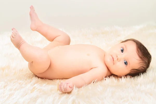 Bebê menina deitada no cobertor peludo — Fotografia de Stock