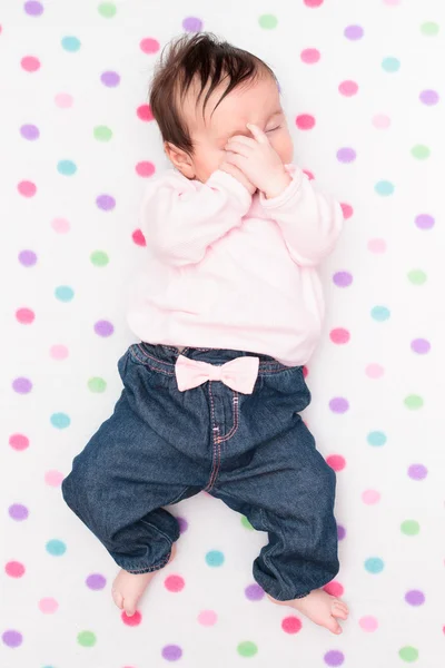 Little baby lying on blanket with colourful polka dots — Stock Photo, Image