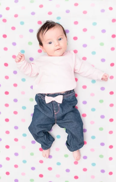 Little baby lying on blanket with colourful polka dots — Stock Photo, Image