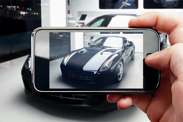 Smart phone mobile photo in car showroom — Stock Photo, Image