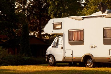 White caravan camper travel car on a campsite