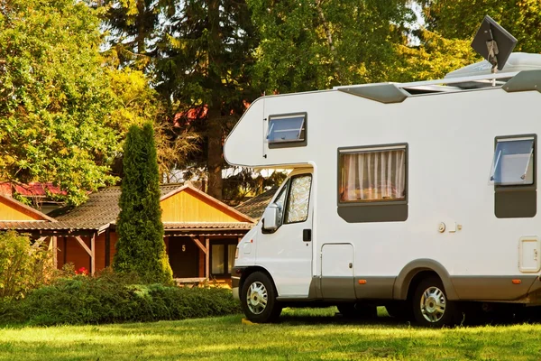 White caravan camper travel car on a campsite