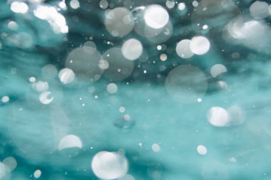 Yüzme havuzunda su kabarcıkları. Kabarcıklı suyun bulanık arka planı