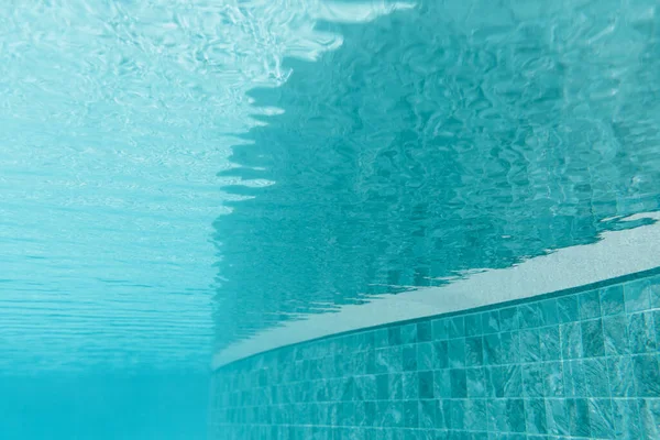 Clean water surface in swimming pool. Water blurred backround.