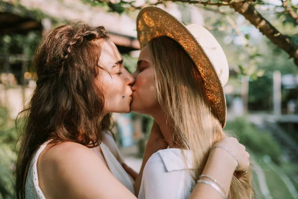 Two happy lesbian women kissing