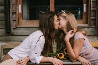 İki mutlu lezbiyenin açık hava kafede randevusu var.