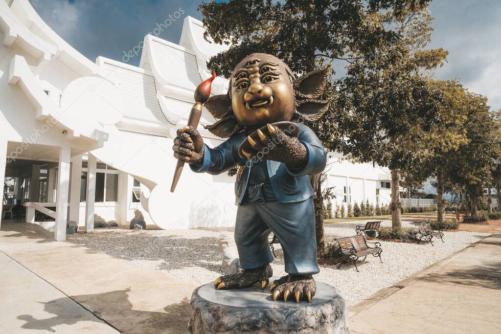 Statue of fairytale character with four eyes Wat Rong Khun, known as the White Temple