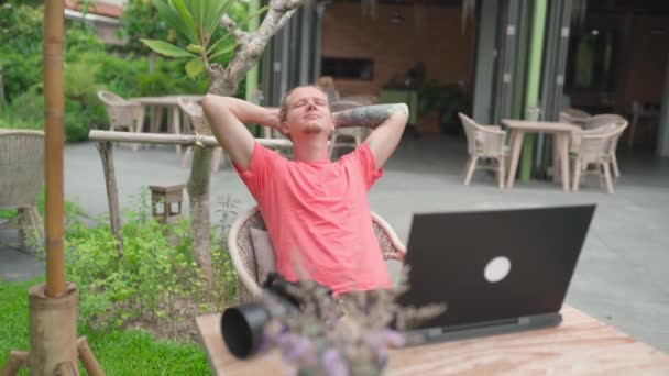 Man Photogrpher Pink Shirt Working Outdoor Cafe Laptop Handheld Shot Stock Video