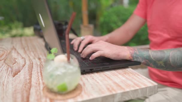 Man Photogrpher Pink Shirt Working Outdoor Cafe Laptop Handheld Shot Royalty Free Stock Video
