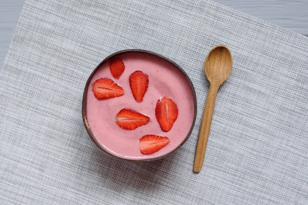 Healthy breakfast superfood smoothie bowl topped with strawberry. close up. delicious berry smoothie bowl. vegan raw food. Selective focus. Flatlay