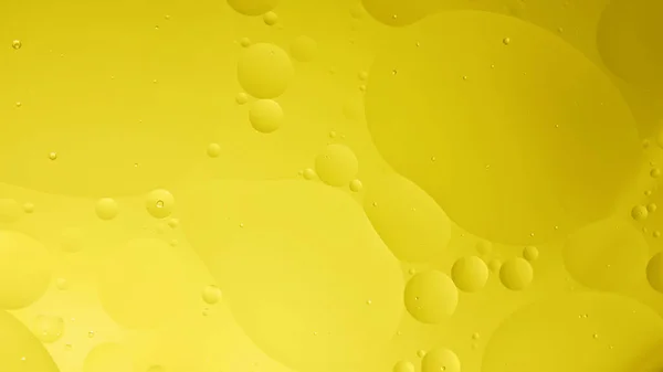 oil with bubbles on yellow,background. Orange Abstract space background. Soft selective focus. macro of oil drops on water surface. copy space. air bubbles in water. color 2021