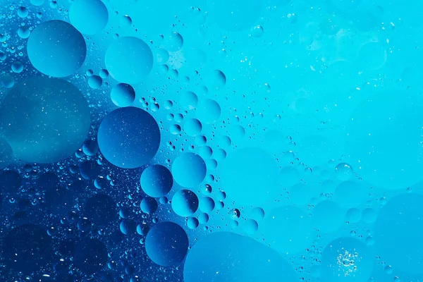 Olja med bubblor på mörkblå bakgrund. Abstrakt bakgrund. — Stockfoto