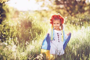 Ukraine's Independence Flag Day. Constitution day. Ukrainian child girl in embroidered shirt vyshyvanka with yellow and blue flag of Ukraine in field. flag symbols of Ukraine. Kyiv, Kiev day clipart