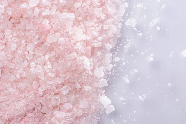 aromatic pink Himalayan sea salt texture background. Homemade Herbal bath salts. Skincare spa beauty bath cosmetic products for relax. Natural skin care. Top view, copy space. Home spa. Aromatherapy