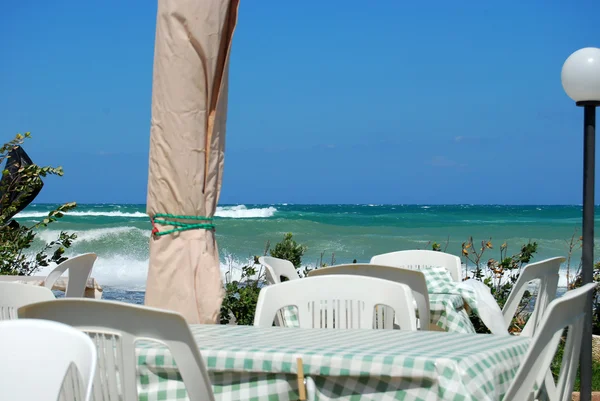 A romantic restaurant on the beach swept by the Mistral in Apuli — Stock Photo, Image