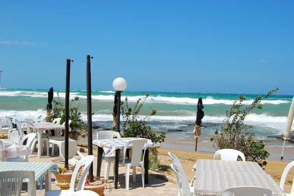 A romantic restaurant on the beach swept by the Mistral in Apuli — Stock Photo, Image