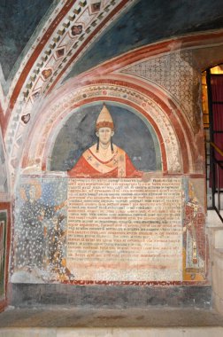 Vestments and paintings in a monastery in the valley of the Bene clipart