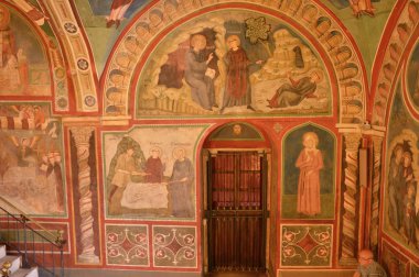 Vestments and paintings in a monastery in the valley of the Bene clipart