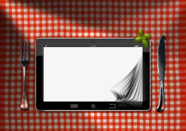 Tablet ve masa örtüsü bir masada çatal bıçak takımı