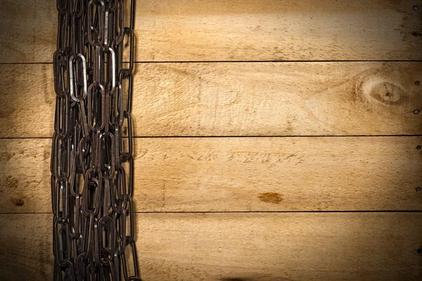 Brązowy łańcucha na podłoże drewniane — Zdjęcie stockowe