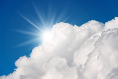 Blue Sky with Clouds and Sun Rays clipart