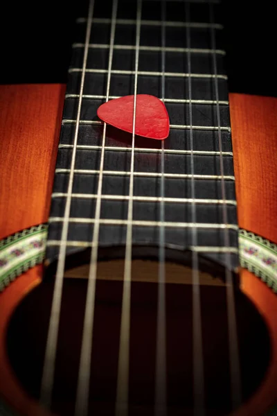 Extreme Closeup Red Guitar Pick Plectrum Strings Fretboard Old Acoustic — Stock Photo, Image