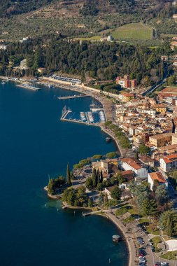 Küçük Garda Kasabası 'nın havadan görünüşü, Garda Gölü kıyısındaki turizm beldesi, göle bakan küçük bir tepe olan Rocca di Garda manzarası. Verona ili, Veneto, İtalya, Avrupa