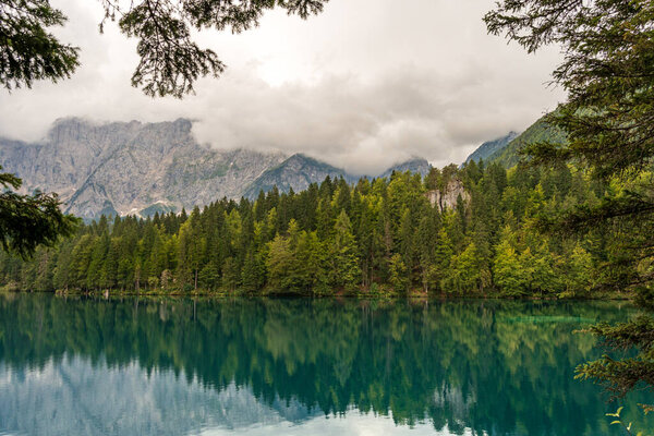 Small Lake of Fusine (Lago Inferiore di Fusine) and the Mountain Range of Mount Mangart, Julian Alps, Tarvisio, Udine province, Friuli Venezia Giulia, Italy, Europe.