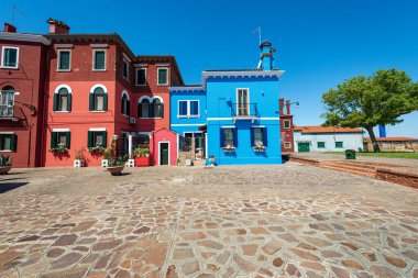 Old small multi colored houses (bright colors) in Burano island in a sunny spring day. Venetian lagoon, Venice, UNESCO world heritage site, Veneto, Italy, southern Europe.