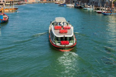 Ferry boat called Vaporetto in a canal of the Murano island, famous for the production of artistic glass, Venice Lagoon, UNESCO world heritage site, Veneto, Italy, Europe.