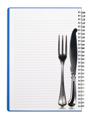 Defter ile gümüş çatal bıçak takımı