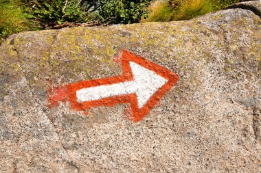 Arrow Marking a Mountaineering Path on a Rock