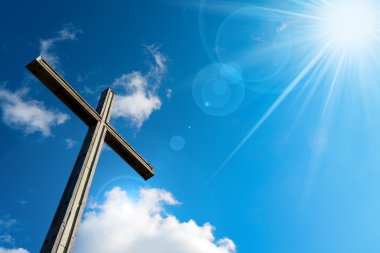Christian Cross Against a Blue Sky clipart