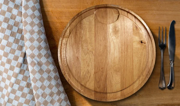 Tábua de corte e talheres - mesa e toalha de mesa — Fotografia de Stock
