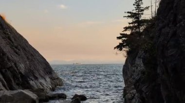 Hafif deniz dalgaları vadiye, yumuşak bir günbatımı gökyüzünün arka planına ulaşır. Doğa manzarası arka planı.