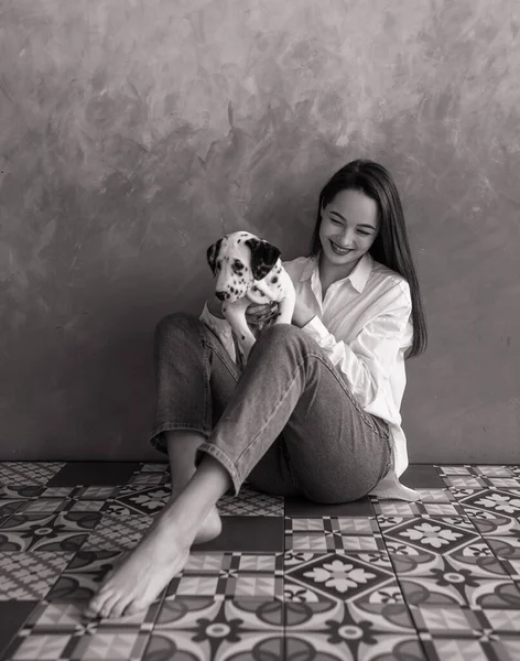 Young Woman Sits Plays Puppy Dalmatian Dog Her Hands Black — Stock Photo, Image