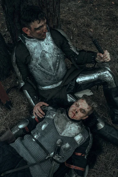 两个穿着链甲的疲惫的中世纪武士躺在树下的森林里 — 图库照片