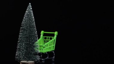Yeni yıl konsepti. Alışveriş, Noel ağacı olan alışveriş sepeti, herkes için hediyeler. Koyu arkaplan, metin için yer.