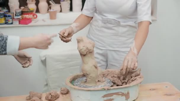 Woman working with clay with her hands. Pottery workshop. master class and training. — Stock Video