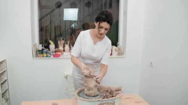 Girl sculptor artist creating a bust sculpture with clay. Sculptor at work. — Stock Video