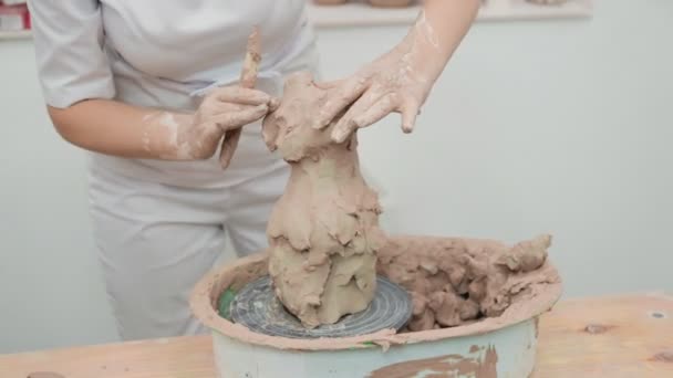 Girl sculptor artist creating a bust sculpture with clay. Sculptor at work. — Stock Video