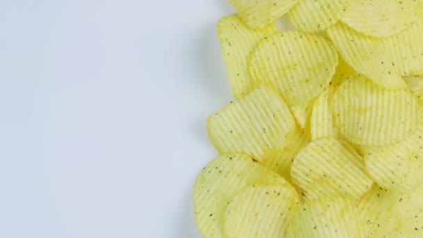 Potato chips macro white background. Unhealthy junk food closeup rotating. Space for text — Stock Video