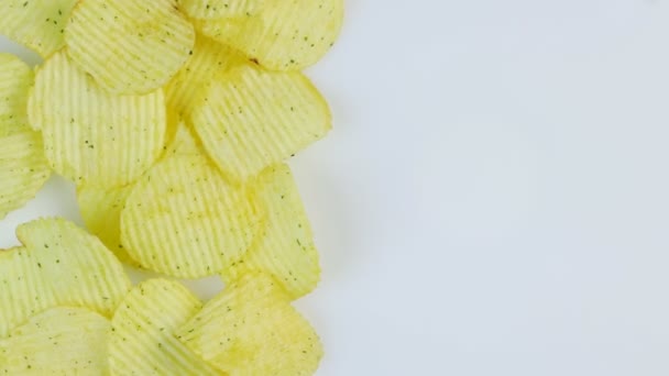 Potato chips macro white background. Unhealthy junk food closeup rotating. Space for text — Stock Video