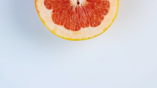 Eine Hälfte einer Grapefruit dreht sich, aus nächster Nähe. Raum für Text. Das Konzept eines gesunden Lebensstils. — Stockvideo